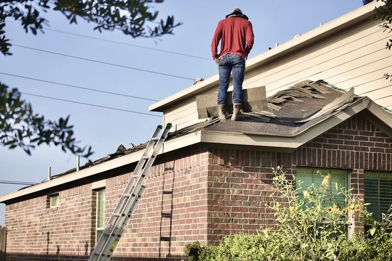 Professional roofer working on a residential roof in Carroll